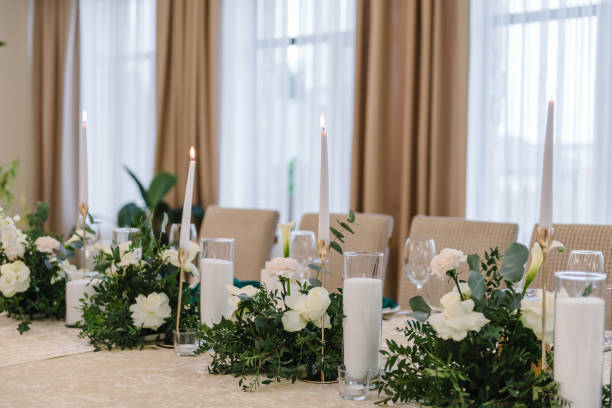 istock Wedding set up, dinner table reception. Flower composition with eucalyptus leaves in the center of the table and burning candles. 1463458467