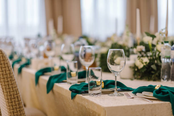 istock Wedding set up, dinner table reception. Flower composition with eucalyptus leaves in the center of the table and burning candles. 1463458471