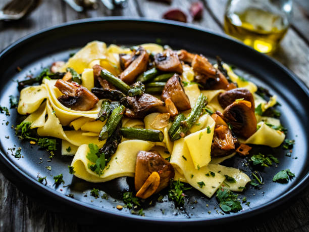 istock Pasta with pesto sauce on wooden background 1463460109