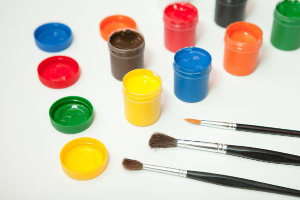 istock gouache paint jars with brushes on white. hobby painting workplace- creativity home teaching drawing 1463462010