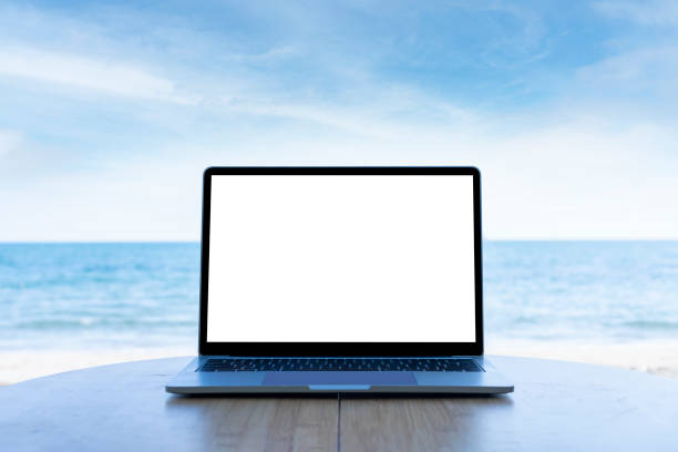 istock office on the beach concept, laptop with empty screen with beach background. 1463462719