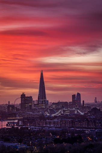 A beautiful sunset sky with vibrant, red colours over the urban skyline of London city, United Kingdom