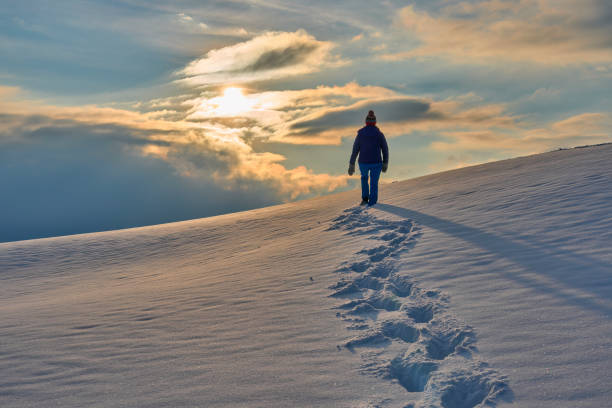 istock woman winter hiking in deep snow during sunset 1463465886