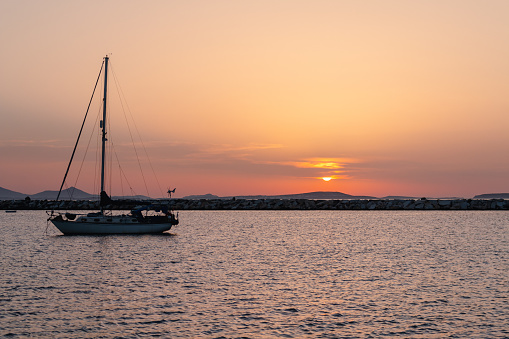 Sailboat in the port of Naxos at sunset.