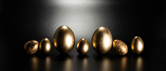 Easter, Gold birds eggs shot against a dark background