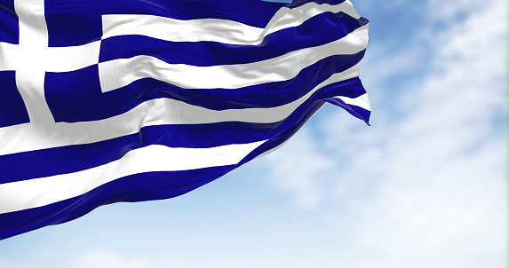 National flag of Greece waving in the wind on a clear day. Greece is a country at the crossroads of Central and Southeast Europe. Fluttering fabric. Realistic 3D illustration