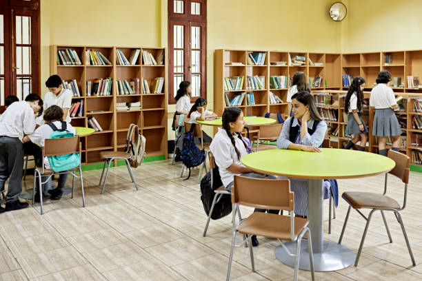 istock School children exploring books at library 1463474805