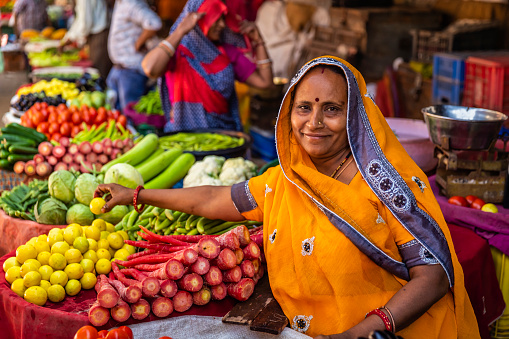 Indian street sellers selling vegetables on the streets of The Pink City in Jaipur, Rajasthan, India. Jaipur is known as the Pink City, because of the color of the stone exclusively used for the construction of all the structures.