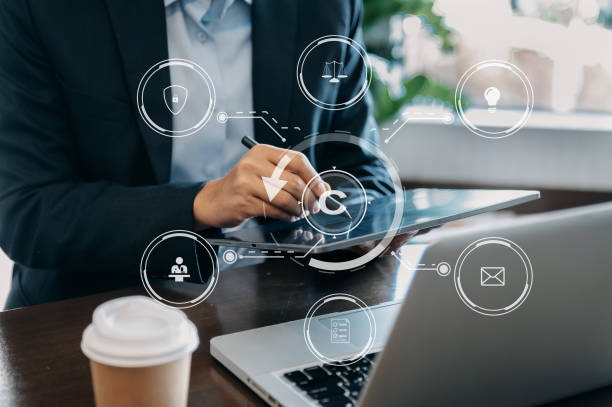 istock Copyright or patent concept, Person hand using laptop computer, tablet and smartphone with virtual screen copyright icon trademark, Creation ownership against piracy. at office 1463477463
