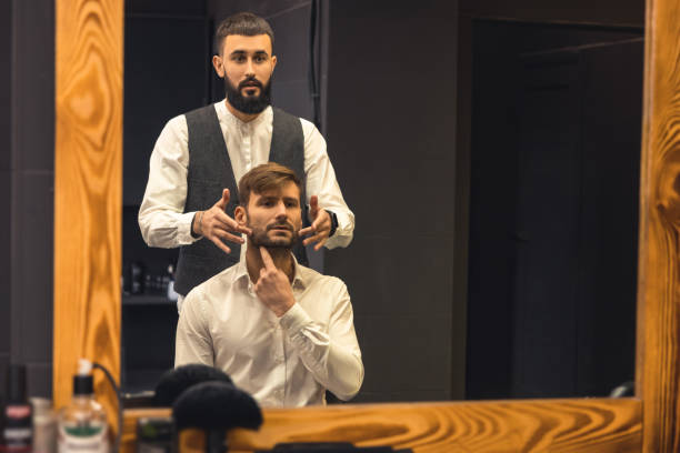 istock Barber working with a customer who sitting at the mirror 1463478648