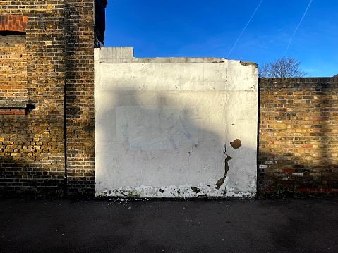 White wall and yellow brick wall on a sunny winters morning