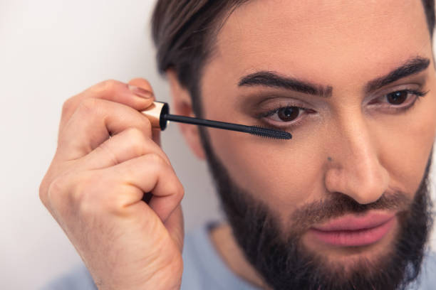 istock Thoughtful young man applying the eye makeup 1463483584