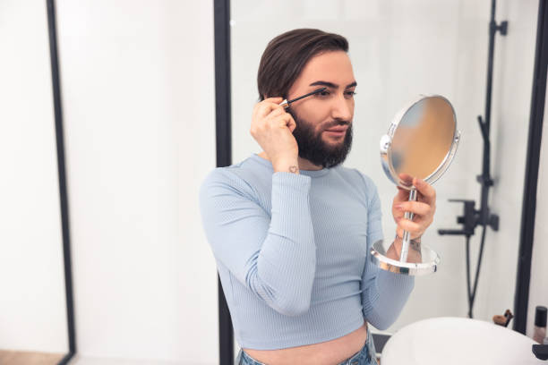 istock Cute young Caucasian man using eye cosmetics 1463483806