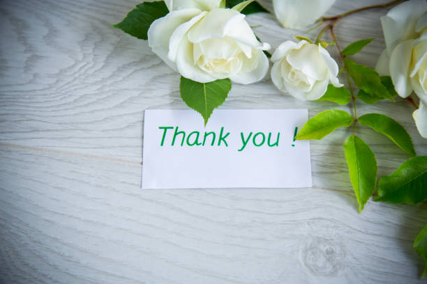 istock beautiful white summer roses, on a wooden table 1463489192