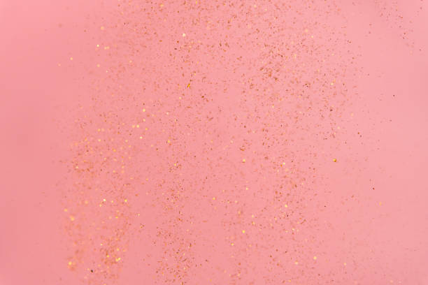istock pink abstract background with flying gold sequins 1463489463