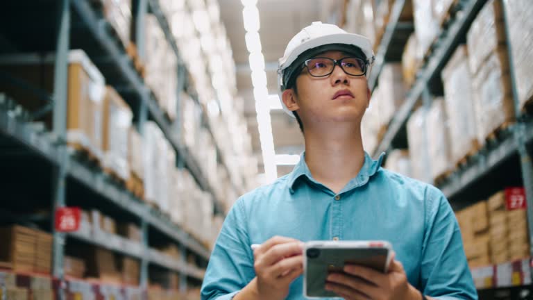 Chinese worker at warehouse in hardhat Retail Warehouse