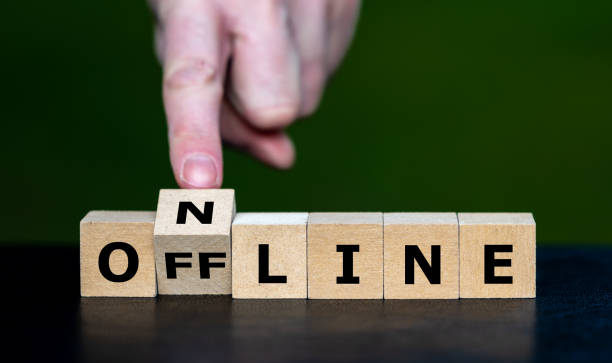 istock Hand turns cube and changes the word offline to online. 1463490345
