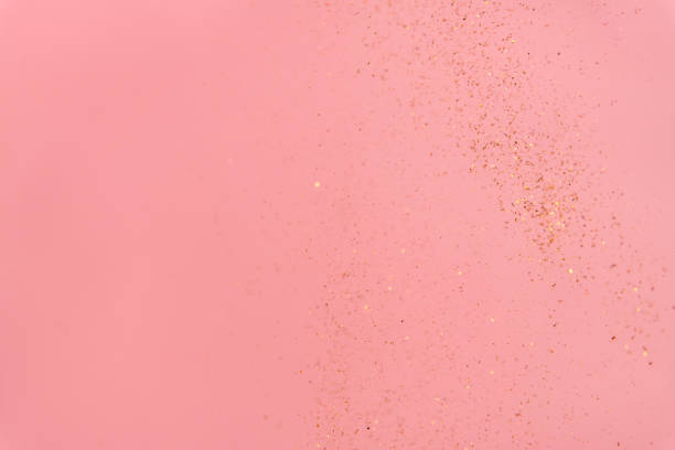 istock pink abstract background with flying gold sequins 1463490493