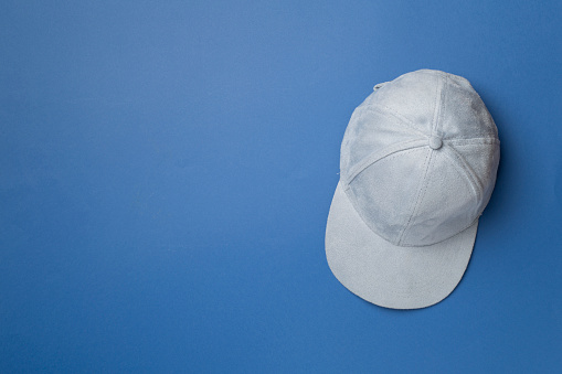 Blue cap on color background, top view.