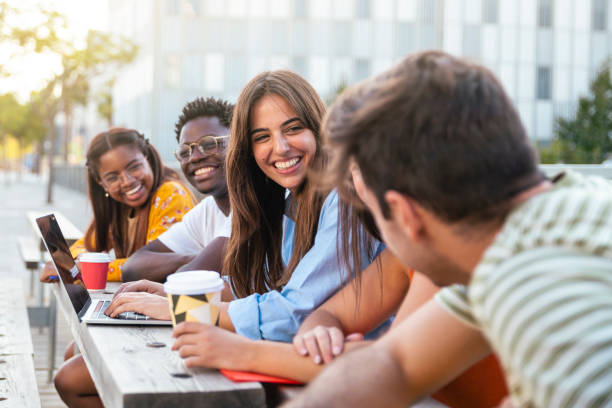 istock Group of five friends having fun together - students talking laughing and enjoying their time - focus on girl - education concept 1463491796