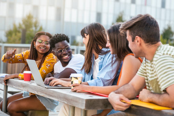 istock Group of classmates discussing and having fun together, focus on man - students talking laughing and enjoying their time - education concept 1463491808