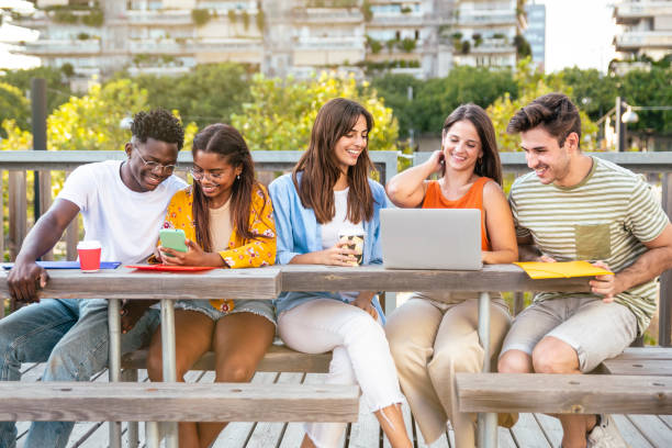 istock Cheerful group of university students studying for exam in the campus - Multicultural group of friends working together outdoors. 1463491816