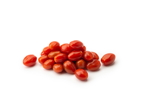 High angle view of Heap of fresh small red sweet snack tomatoes on white background