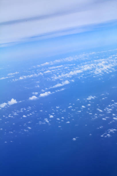 istock Cloudscape background. View from above, out of an airplane window. Grey cloudy sky. 1463492378
