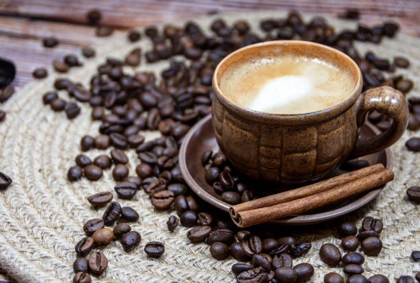 istock Cup of coffee, cinnamon stick and coffee beans on the table 1463492553