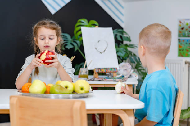 istock Children eating a fruit snack in a kindergarten 1463493870
