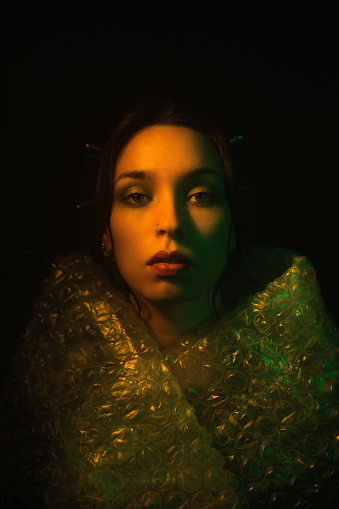 Woman portrait illuminated neon light 
trapped concept