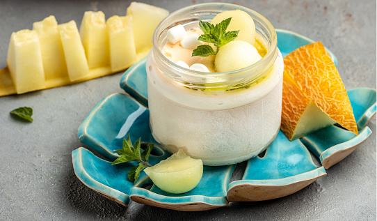 Delisious ice cream with melon and mint, in a glass jar. banner, menu, recipe place for text, top view.