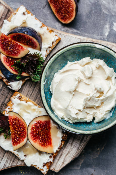 istock Bowl of philadelphia cream cheese and fresh figs. vertical image. top view 1463496643