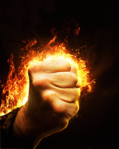 istock Burning rage: man's fist bursting into flames and fire 1463497681