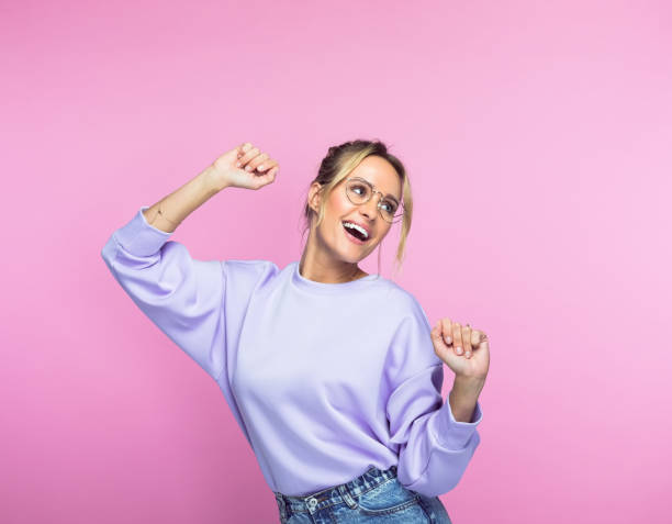 istock Cheerful woman dancing against pink background 1463497751