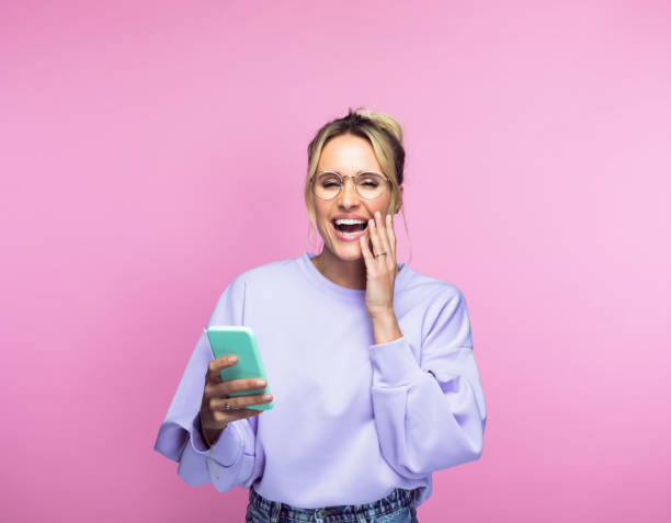 istock Happy woman with smart phone 1463498205