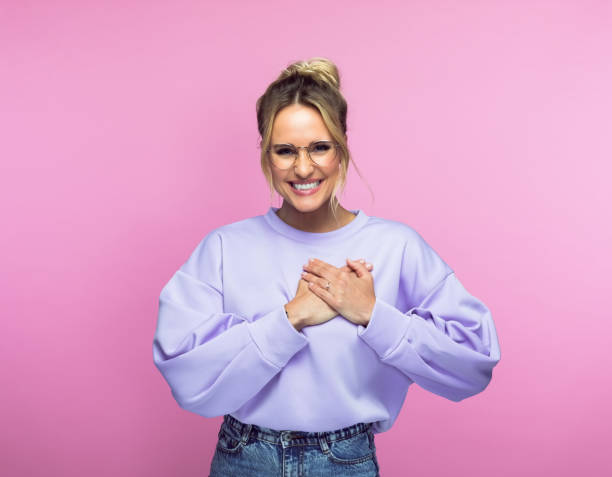 istock Smiling woman keeping hands on heart 1463498547