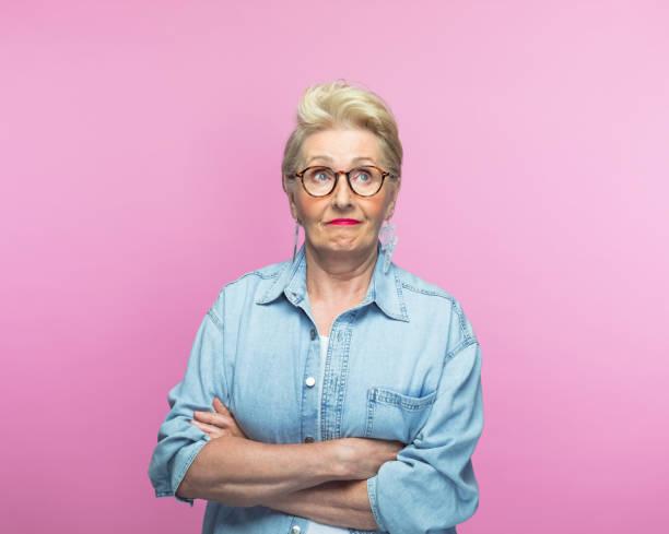 istock Contemplative elderly woman with arms crossed 1463498716