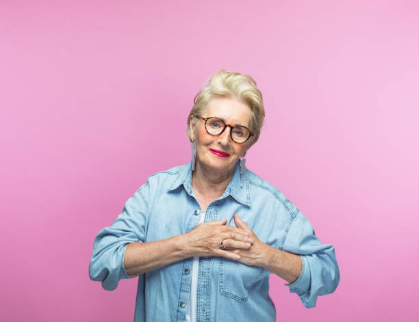 istock Elderly woman keeping hands on heart 1463498867
