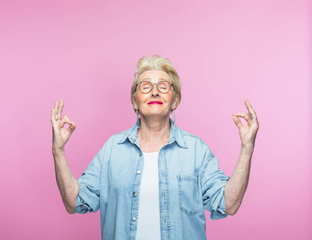 istock Elderly woman meditating with eyes closed 1463498902