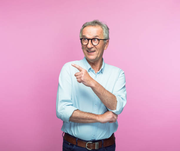 istock Happy senior man pointing at copy space 1463499966