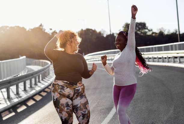 istock Two young plus size women jogging together. 1463500026