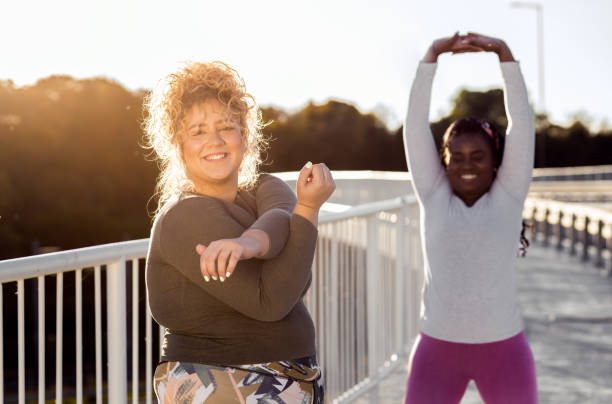 istock Two young plus size women stretching together before runnung. 1463500118