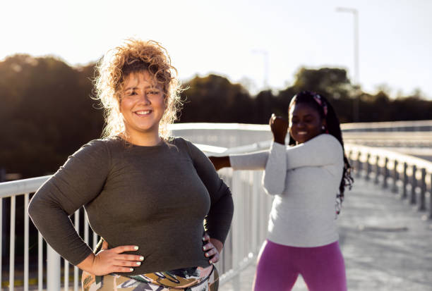 Portrait of two young plus size women preparing for run.