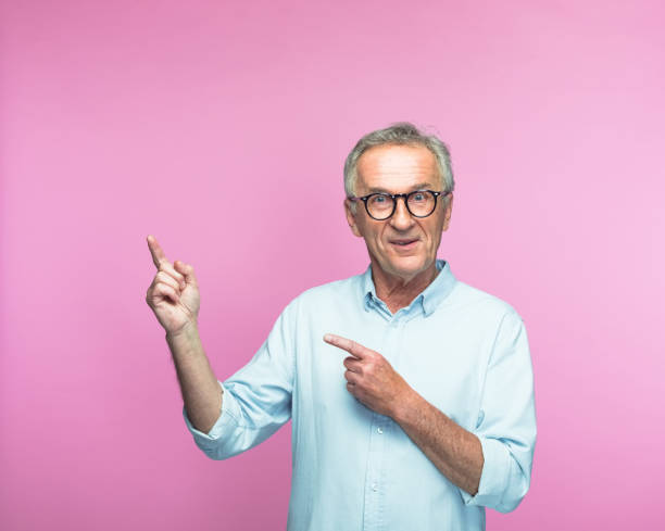 istock Smiling senior man pointing at copy space 1463500349