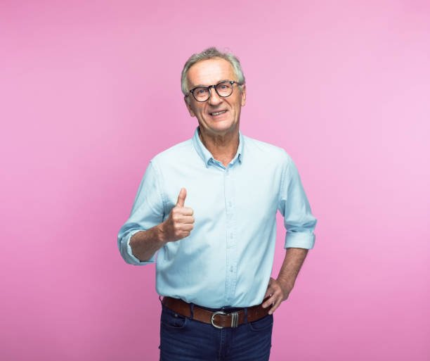 istock Smiling senior man showing thumbs up 1463500383