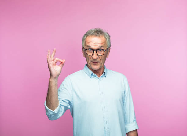 istock Surprised senior man showing OK sign 1463500416