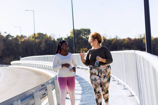 istock Two young plus size women relaxing after running. 1463500448