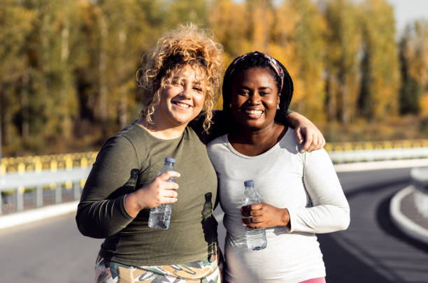 istock Portrait of two young plus size women preparing for run. 1463500519