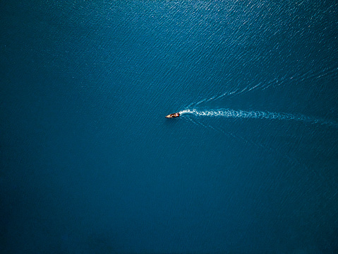 Aerial view of boat in the sea. Travel freedom concept. Shoot directly above